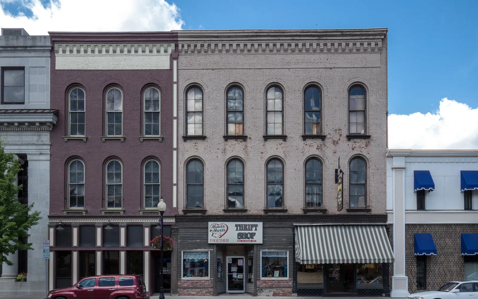 A historic downtown street with period architecture and community buildings representing traditional civic centers